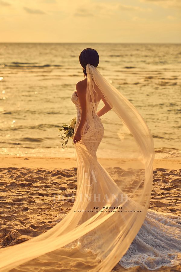 The An Thoi plain sheer cathedral veil floating on a beach at sunset