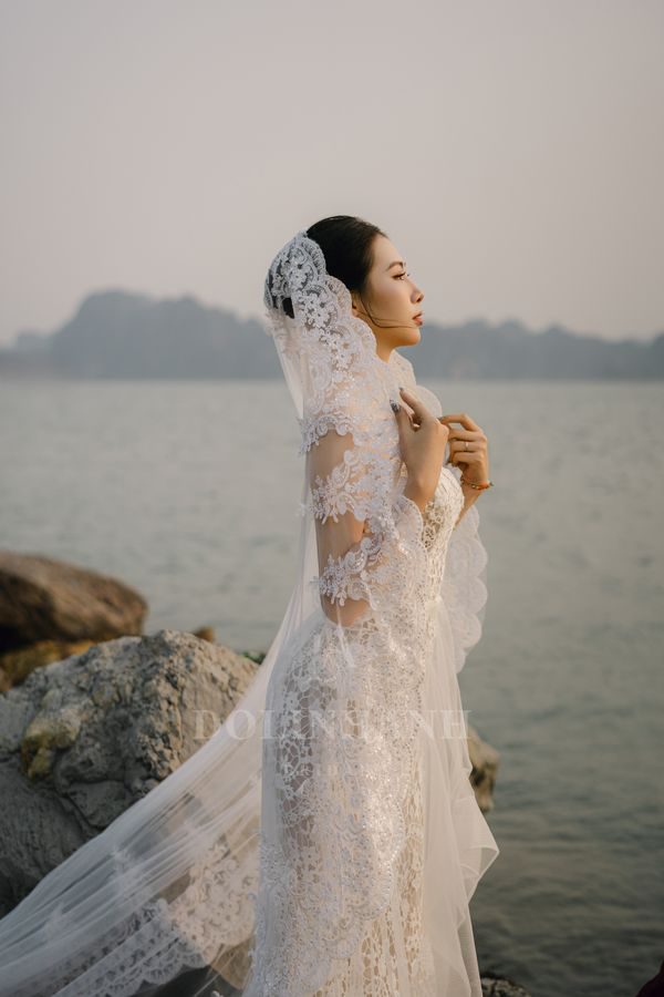 The Hoi An scalloped lace mantilla wedding veil on a bride in Ha Long Bay