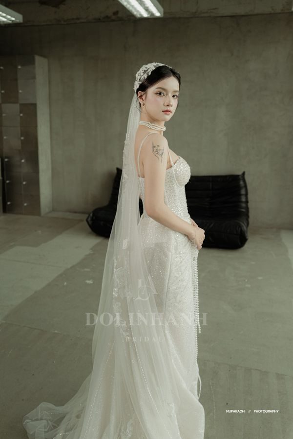 The Ninh Binh lace motif cathedral wedding veil on a bride in a studio