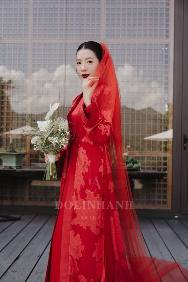 The Red River red tulle wedding veil worn with a red ao dai