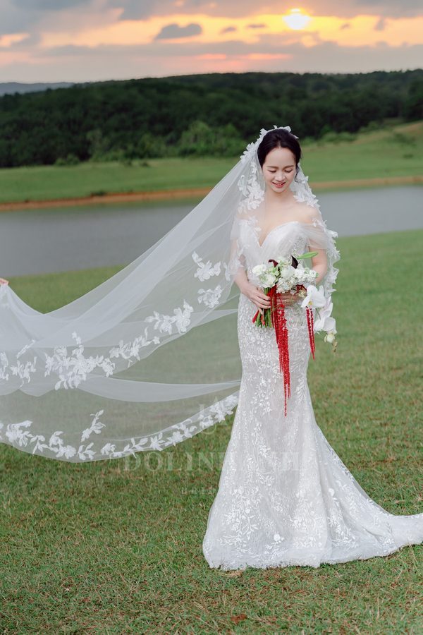 The Ta Dung leaf vine lace cathedral veil floating in the wind at sunset